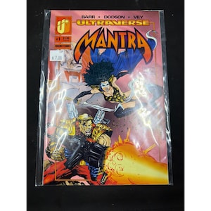 May include: A comic book titled "Mantra" from Malibu Comics, issue #1. The cover art features a female character with dark hair and a blue cape, wielding a sword, and a male character with a gun. The comic is in a plastic sleeve.