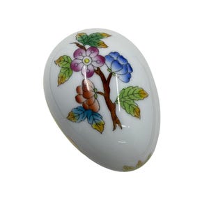 May include: A set of three ceramic mugs with a speckled, matte finish. The mugs are in shades of cream, light gray, and dark gray. Each mug has a simple, minimalist design and a rounded handle.