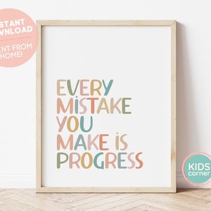 May include: A printable poster with the text "Every mistake you make is progress" in colorful, stylized lettering. The poster is framed in a light wood frame and is set against a white wall.