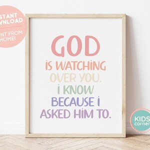 May include: A framed print with a colourful quote that reads "GOD IS WATCHING OVER YOU. I KNOW BECAUSE I ASKED HIM TO."