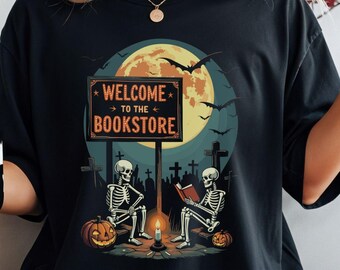 Welcome to the Bookstore Halloween Shirt – Skeletons Reading by Campfire | Spooky Book Lover Tee