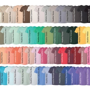May include: A variety of t-shirt colors, including heather clay, military green, white blend, deep teal, autumn, prism natural, olive, aqua, ice blue, peach, tan, prism dusty blue, sunset, dust, prism mint, prism blue, orange, sand dune, dusty blue, prism sunset, mint, brown, prism peach, seagreen, prism ice blue, cement, prism lilac, columbia blue, kelly, cool grey, raspberry, blue, green, athletic heather, orchid, midnight navy, navy, stone, maroon, grass green, storm, red, forest, true royal, deep heather, cardinal, emerald, lapis, canvas red, dark grey heather, purple, team purple, mauve, charity pink, yellow gold, black heather, yellow, solid black blend, bubblegum, and mustard. The shirts are all short-sleeved and have a crew neck.