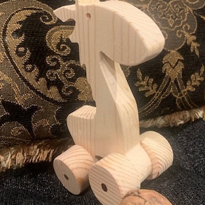 Wooden giraffe on wheels