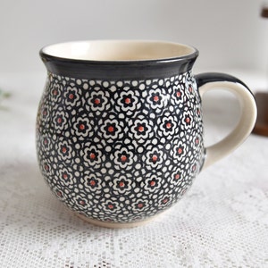 Handmade polish pottery mug with loop handle by Boleslawiec ceramic made in Poland with black flowers