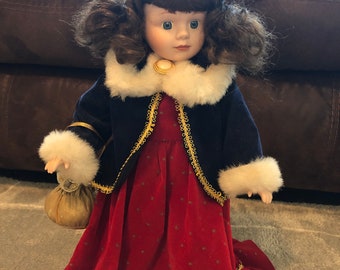 Beautiful porcelain doll,with a velvet dress.