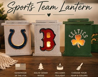 May include: Three rectangular wooden lanterns with cutouts of sports team logos. The left lantern is white with a blue horseshoe, the center is white with a red letter B, and the right is green with a white shamrock and the text CELTICS.