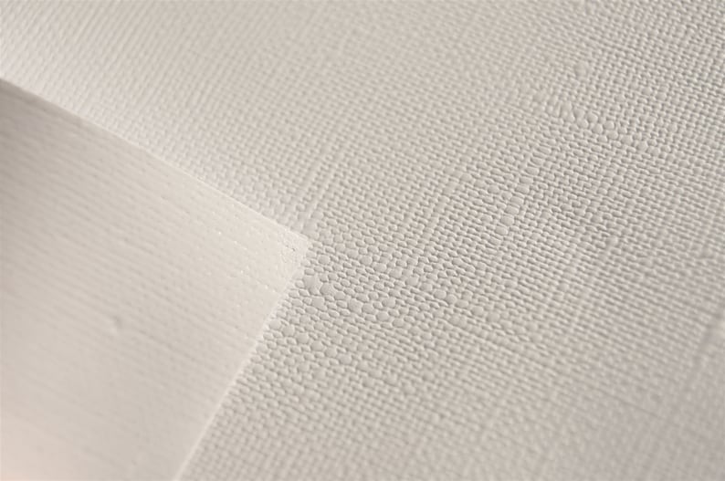 May include: Close-up of a white textured surface with a subtle pattern. The surface has a slightly raised, textured feel.