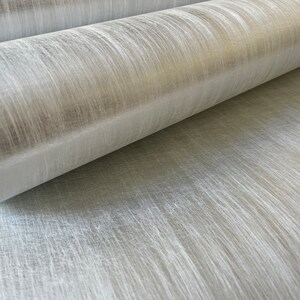 a close up view of a beige wallpaper