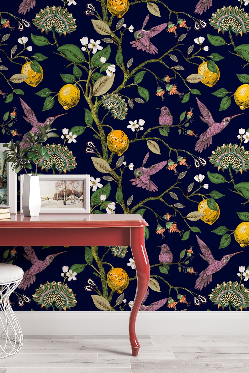 May include: A red table with a dark blue wallpaper featuring a repeating pattern of lemons, flowers, and hummingbirds. The wallpaper has a vintage aesthetic.