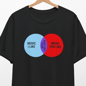 May include: Black t-shirt with a Venn diagram graphic that says "Music I Like" and "Music You Like". The overlapping section says "Music We Like".