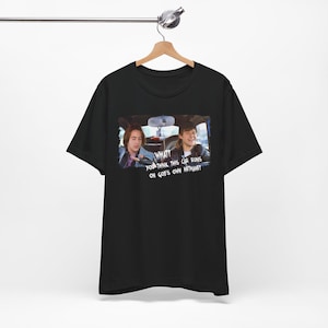 May include: Black t-shirt with a graphic of two men in a car. The text on the graphic reads "What you think this car runs on God's own methane?"