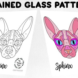 May include: A black and white line art image of a Sphinx cat's face with numbered sections for a stained glass pattern. The image is labeled "Sphinx" and has a copyright notice.