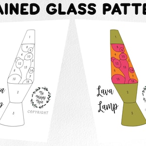 May include: A printable stained glass pattern of a lava lamp with numbered sections. The pattern is in black and white with the words "Lava Lamp" and "The Makers Trove" in a wreath.