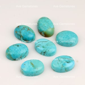 May include: Seven oval-shaped turquoise cabochons, ranging in size and colour, with a light blue to greenish-blue hue. The stones have a smooth, polished surface and are set against a white background.