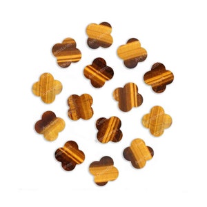 May include: A collection of twelve brown and gold tiger's eye gemstone flower-shaped cabochons.