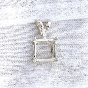 May include: A silver pendant setting with a square frame and a V-shaped bail. The setting has small ball accents at each corner of the square. The pendant is designed to hold a gemstone.