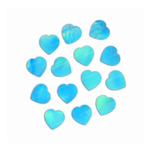 May include: A scattering of iridescent blue heart-shaped stones on a white background. The stones have a light blue and green color with a shimmery finish.