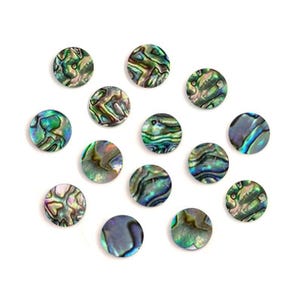 May include: A collection of iridescent, round abalone shell pieces. The shells display a mix of green, blue, and purple hues with a swirling pattern. These decorative shells are arranged on a white background.
