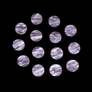 May include: A close-up of 12 purple and white patterned circles with the text "Ave Gemstones" repeated on each circle.