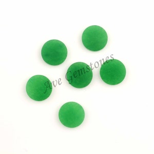 May include: Five round, green cabochon gemstones on a white background. Ave Gemstones is written in black text on the background.