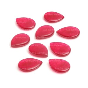 Puede incluir: Ocho piedras preciosas de color rosa brillante en forma de lágrima. Las piedras preciosas son lisas y pulidas.