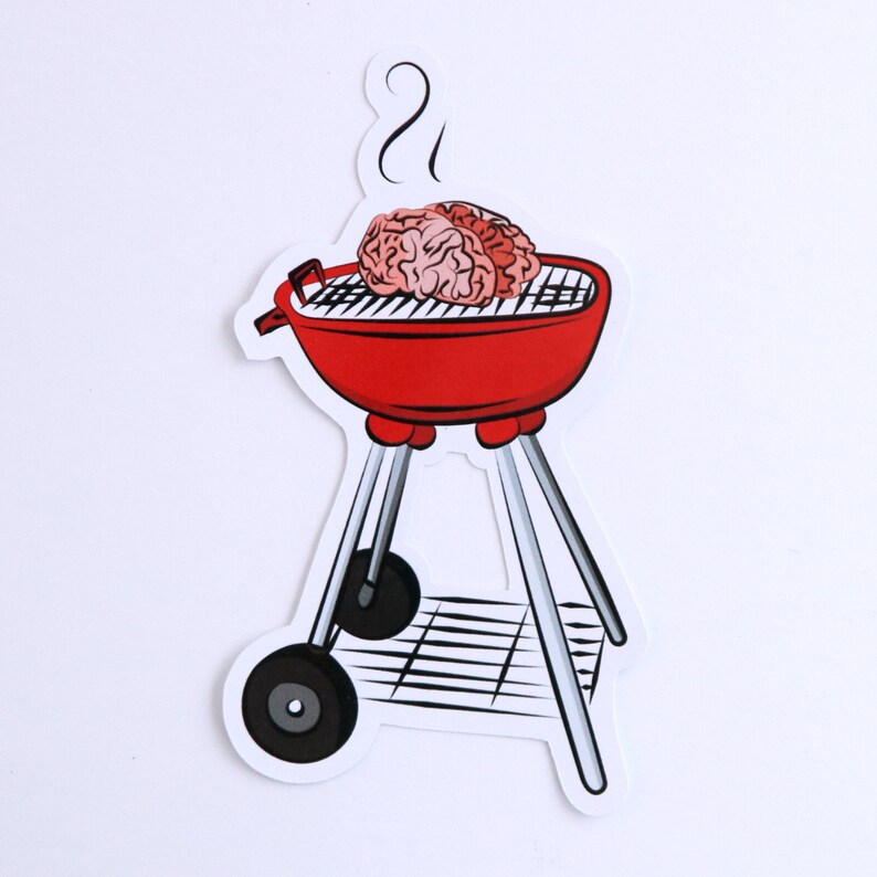 May include: A red grill with a brain on top of it. The grill has a black grate and a black handle. There is smoke coming from the top of the grill.