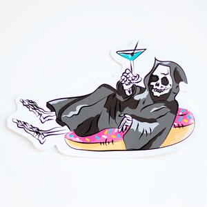 May include: A black and white illustration of the Grim Reaper relaxing on a pink and white doughnut float with a blue cocktail in hand.