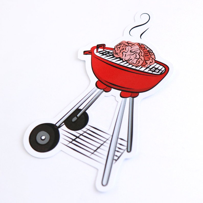 May include: A red and silver grill with a pink brain on the grill grate. There is a small wisp of smoke coming from the top of the grill.