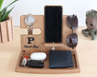 May include: Wooden desk organizer with slots for a smartphone, watch, and sunglasses. Includes a tray for keys, wallet, and earbuds. The organizer is engraved with the letter "P" and the name "Patrick Shaw".