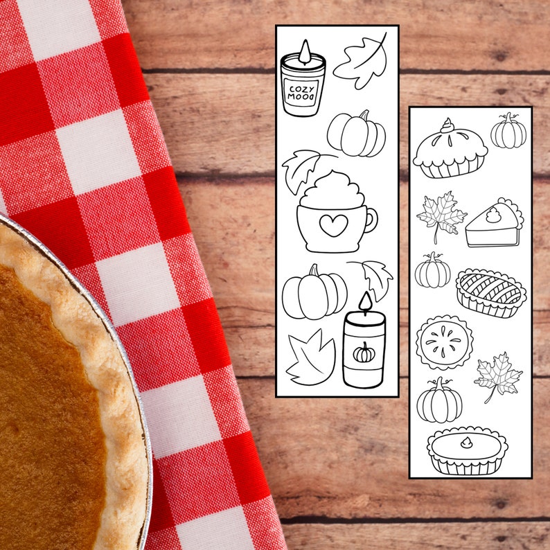 May include: Two printable sheets of black and white fall-themed illustrations. The first sheet features a candle, a pumpkin, a cup of hot cocoa, and leaves. The second sheet features a pie, a pumpkin, a candle, and leaves.