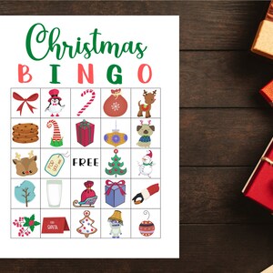 May include: A printable Christmas Bingo card with 25 squares. Each square contains a different Christmas-themed image, such as a reindeer, a snowman, a Christmas tree, a gift, and a stocking. The center square says "FREE".