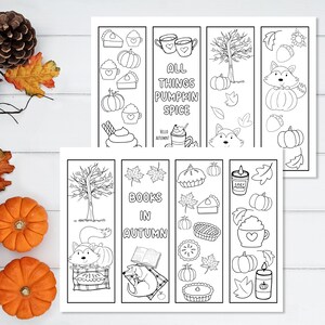 May include: Set of six printable bookmarks featuring autumn themes. The bookmarks include illustrations of pumpkins, pies, leaves, a fox, a dog, a tree, and a cup of coffee. The text on the bookmarks reads "All Things Pumpkin Spice", "Books in Autumn", and "Cozy Mood".