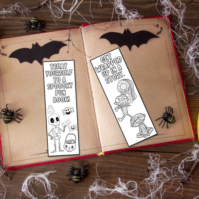May include: Two black and white printable Halloween bookmarks. The first bookmark features a skeleton holding a candy bucket and the text "Treat yourself to a spooky fun book!" The second bookmark features a mummy, a witch, and a vampire and the text "Get wrapped up in a story."