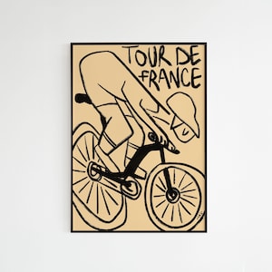 Peut inclure: Illustration en noir et blanc d'un cycliste sur un vélo, avec les mots "TOUR DE FRANCE" en lettres noires. L'œuvre est posée sur un fond beige et encadrée en noir.