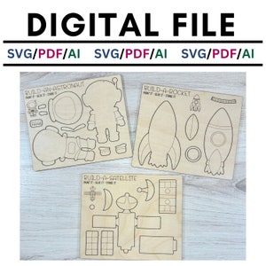 May include: Three printable craft templates for building an astronaut, rocket, and satellite. Each template is on a light brown wooden background with black outlines and the text "BUILD-AN-ASTRONAUT", "BUILD-A-ROCKET", and "BUILD-A-SATELLITE".
