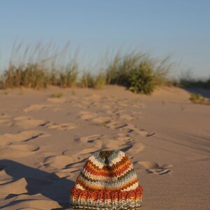 May include: A set of three ceramic vases in varying heights. The vases have a matte finish in shades of cream, beige, and brown. The tallest vase is approximately 10 inches high.