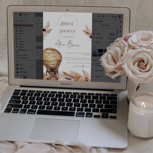 May include: A digital invitation for a bridal shower for Alina Brown. The invitation features a watercolor illustration of a wicker chair, pampas grass, and flowers in shades of pink, brown, and beige. The text "Please join us for a bridal shower" is written in a script font.