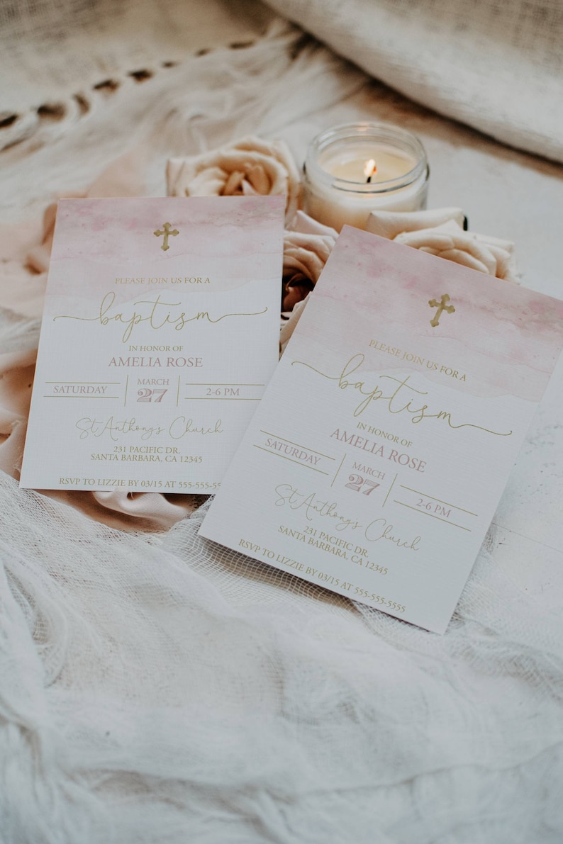 May include: Two pink and white watercolor baptism invitations with gold lettering. The invitations announce a baptism for Amelia Rose on March 27th at 2:00 PM at St. Anthony's Church. The invitations include the church address and an RSVP request.
