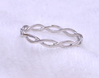 May include: A silver braided ring with a simple design.
