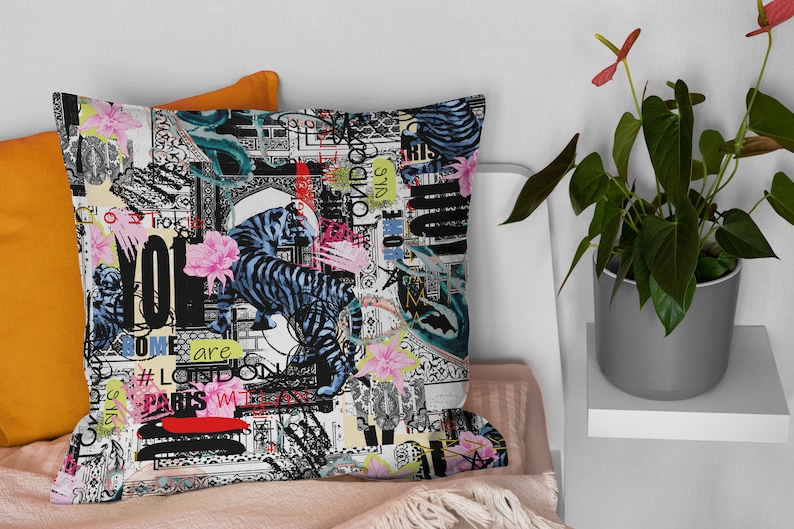 May include: A black and white cushion with a colourful abstract design featuring tigers, flowers, and text. The text includes "Some are", "#London", "Paris", and "Yo!"