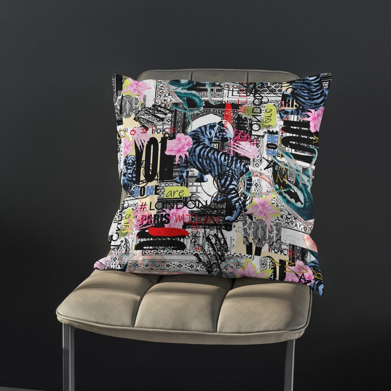 May include: A white throw pillow with a colourful, graphic print featuring a black tiger, flowers, and text that says "You are some are #London Paris in the gas"