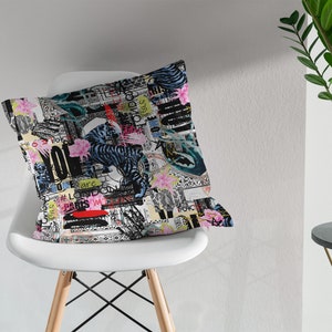May include: A white throw pillow with a colourful, abstract print featuring a tiger, flowers, and text. The text includes the words "Love", "Paris", and "London".
