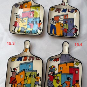 May include: Four square ceramic dishes with handles, each featuring hand-painted scenes of colourful houses, laundry lines, and figures. The dishes are labelled 15.1, 15.2, 15.3, and 15.4, showcasing vibrant orange, blue, red, and yellow architectural details.