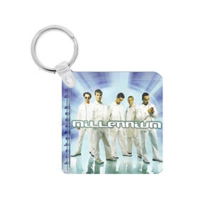 May include: Square keychain featuring a group of five people in white outfits. The word "Millennium" is displayed in a green and white font. The background has a blue and white gradient design. The keychain has a silver ring.