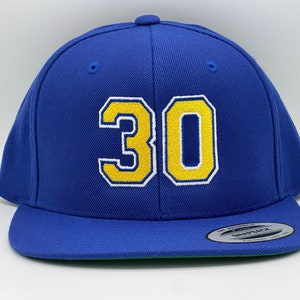 May include: A royal blue baseball cap with a yellow and white embroidered number "30" on the front.