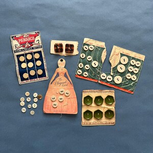 May include: Assortment of vintage button cards with various colours and designs. The cards feature different button sizes and styles, including round, square, and oval buttons. The cards are labelled with the number of lines and the brand name "Monarch".