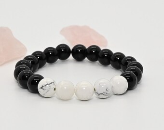 May include: Black and white beaded bracelet with black onyx and white howlite beads.