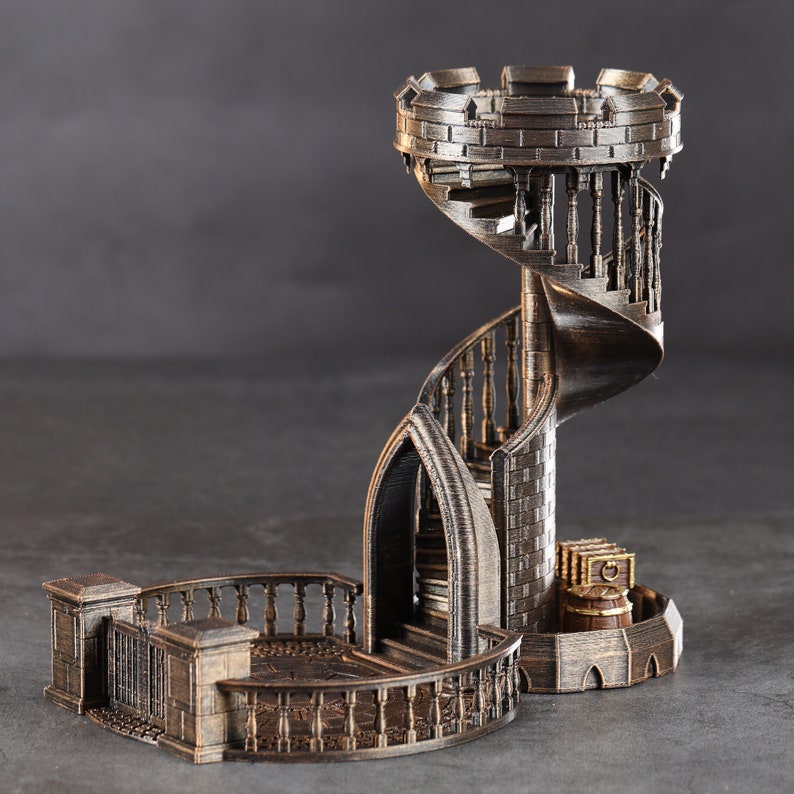 May include: A 3D printed metal model of a spiral staircase with a tower at the top. The staircase is made of a dark metal and has a detailed design. The tower has a small balcony and a pointed roof.