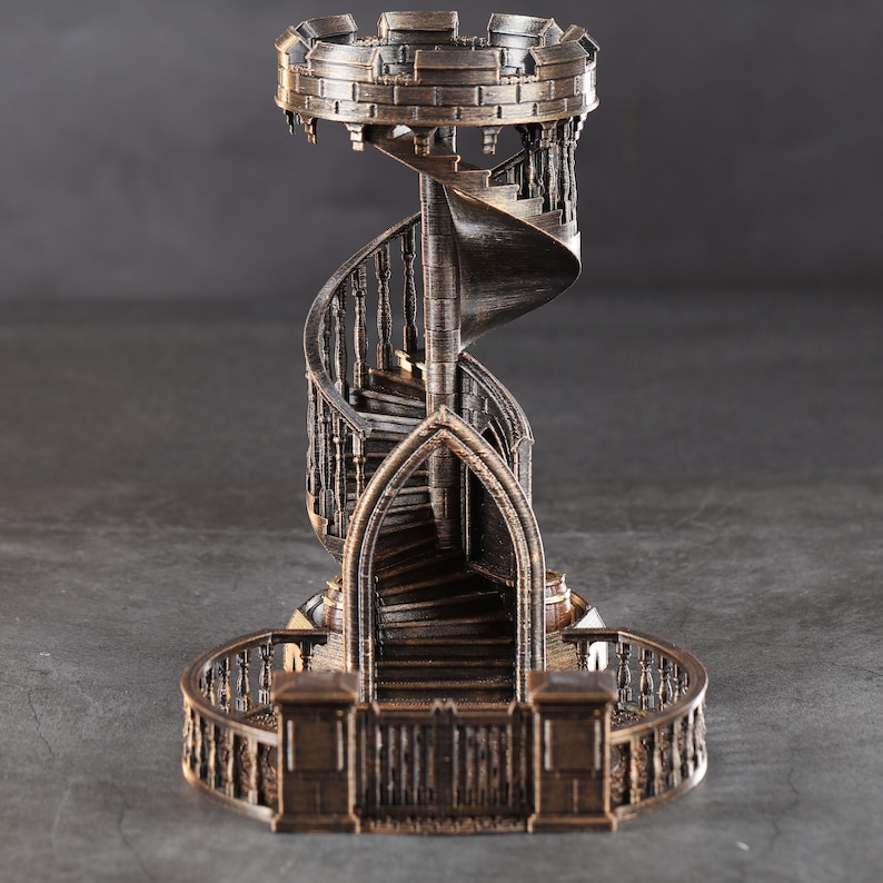 May include: A detailed miniature of a spiral staircase with a stone-like finish. The staircase is surrounded by a decorative railing and has a small platform at the top.