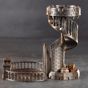 May include: A 3D printed, bronze-colored tower with a spiral staircase and a small balcony. The tower is made of a brick-like material and has a detailed design.